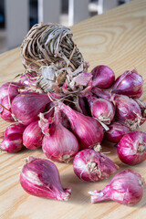 Fresh Red Onions on Wooden Table