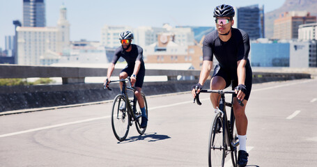 Fototapeta premium Athlete, men and cycling on bike in city for marathon practice, competition workout or fitness. Active, people and bicycle in road for cardio exercise, endurance challenge and pace training for sport