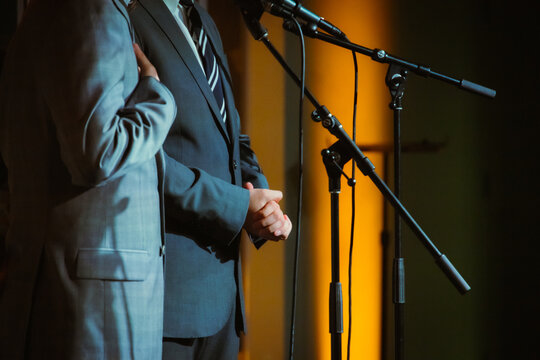 a performer is holding his hands on the stage