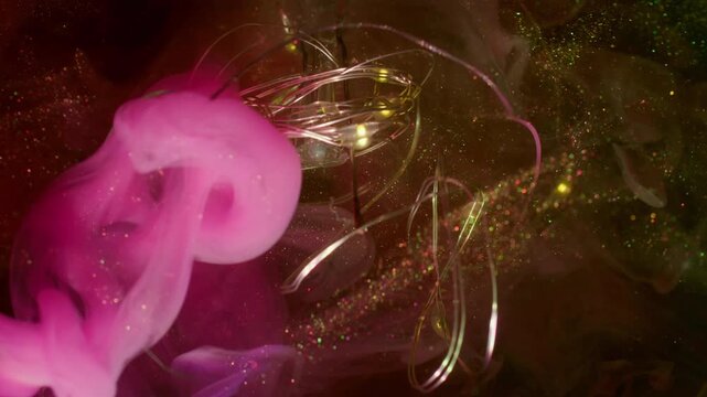 Haze wave defocused. String garland glow. Broken glass bokeh light bulb abstract sparkling water. Pink yellow color ink smoke black background.