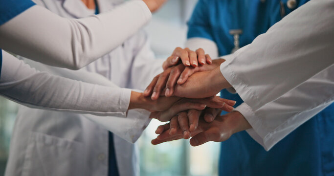 Closeup, nurses and doctors with handstack in hospital for celebration, surgery success and victory. People, healthcare workers and huddle for medical milestone, staff motivation and team achievement