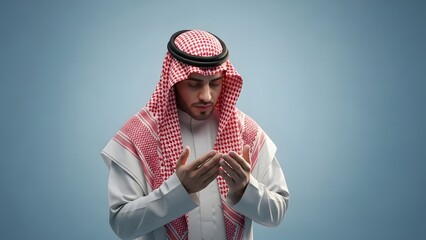 Man in traditional Middle Eastern attire praying