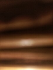 Abstract warm brown blurry background with soft horizontal light