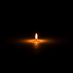 Fototapeta premium Single Candle Flame Burning in Darkness Creating Warm Glow