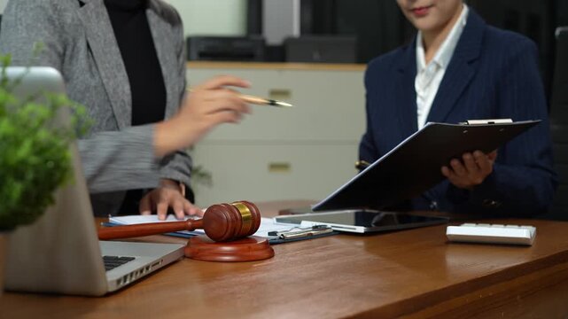Lawyer businesswoman and two business partners working together in office.