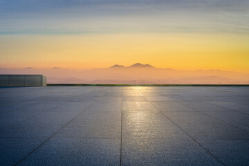 Empty square floor and mountain with beautiful sky at sunrise