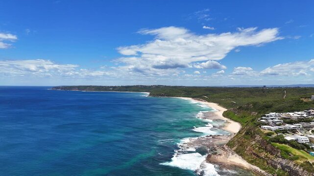 Aerial looking south along Merewether rocky headland and open ocean, dolly establish