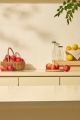 A small basket of apples and lemons with glass bottles decorated with countertop. Scene for advertising detox drinks, infusion recipes, or product and label placement