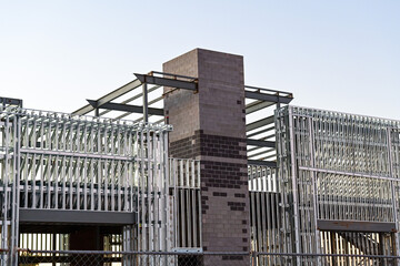 A commercial building under construction with steel framing and masonry core, illustrating structural assembly, mixed material construction methods, and large scale commercial development