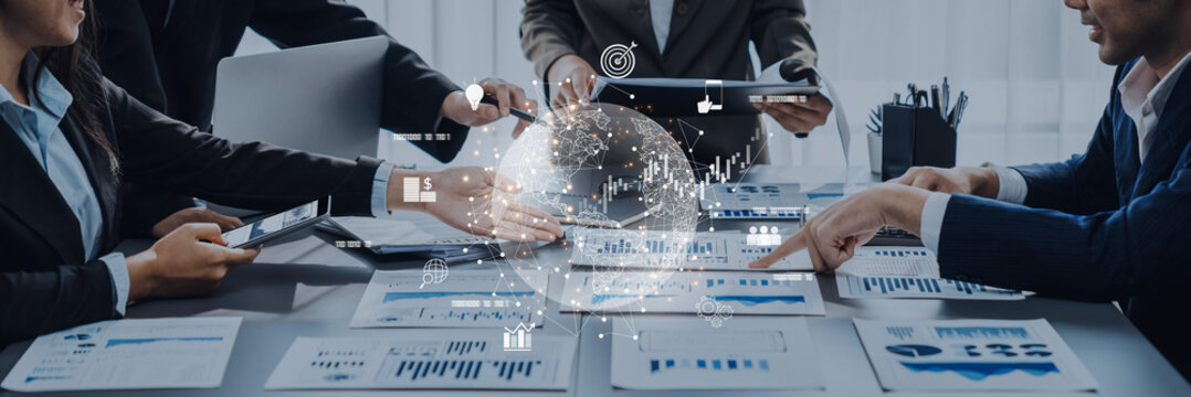 A diverse business team engages in data analysis in a modern office, focusing on charts and digital graphs to drive strategic planning and informed decision making. Trope - Powered by Adobe