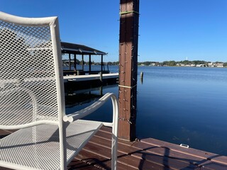 Lake Roy clear blue sky relaxing scene brown deck white chair