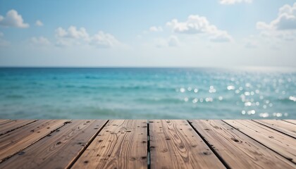 Wood tabletop foreground against blurred sparkling sea water and bright summer sky background