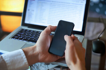 hands holding smartphone with empty black screen, mobile phone with blank screen