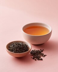 Beige Ceramic Teacup With Loose Leaf Black Tea On Pink Background