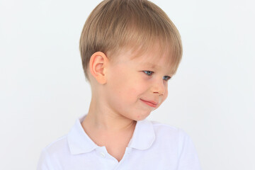 emotional portrait of a 4-6-year-old boy on a white background, cheerful and surprised child