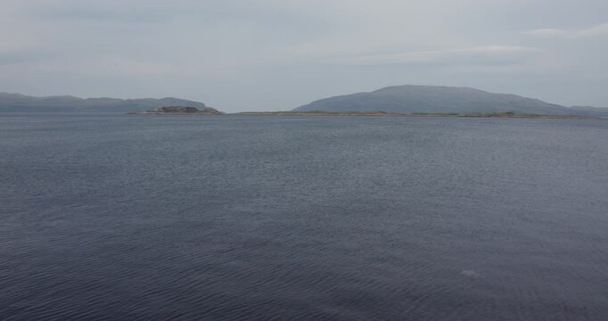 Wide panning shot of the Sound of Jura with Islands of Reisa Mhic Phaidean , coiresa, and Scarba in background