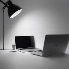 Modern workspace with two laptops, lamp, and coffee cup on a clean white desk in a minimalist office setting