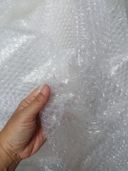 Fototapeta premium Bubble wrap, a pliable transparent plastic material for protecting fragile items during shipping.