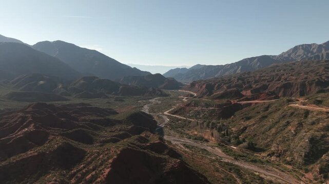 Drone fly at Cuesta de Miranda mountain valley with winding Route 40 highway road cutting through rugged mountainous terrain, Chilecito, La Rioja, Argentina