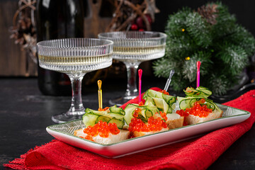 Christmas and New Year's dishes. Snacks and wine drinks for the holiday table. Canapes with red salmon caviar. Overhead