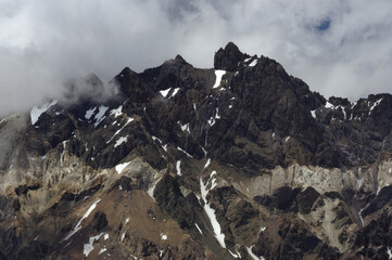 The enchanting beauty of the snowy mountains. The view of snow and rocks on the mountain tops.