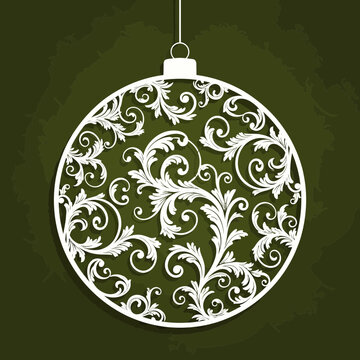Elegant white paper cut style christmas ornament with intricate baroque scrollwork design hanging against a dark green background