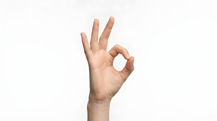 Naklejka premium Expressive human hand making the internationally recognized 'OK' sign, conveying concepts of perfection, approval, and success with a clear, isolated presentation on a bright, uncluttered backdrop