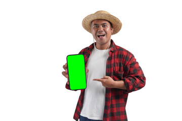 A man in a plaid shirt and straw hat is holding a green screen cell phone. He is smiling and he is happy