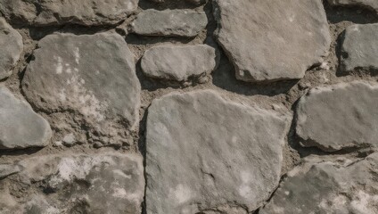Close-up of a textured natural stone wall with rough surfaces and irregular shapes.