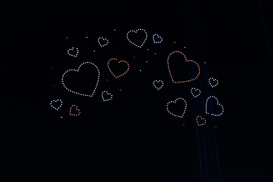Abstract Image of Floating LED Hearts Against a Black Background (Drone Light Show, Valentine's Day Concept, Clean Image Quality)