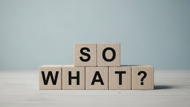 Wooden blocks spelling the phrase so what? representing indifference or questioning significance