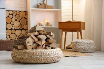 Fototapeta premium Interior of living room with shelving unit, wicker ottoman and firewood