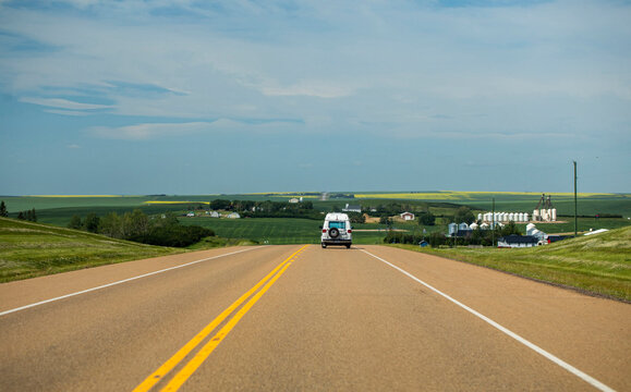 A White Van Drives on a Rural Highway in Saskatchewan