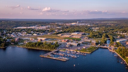 Naklejka premium Aerial View of Lac-Megantic, Quebec, Canada With Boats Docked on the harbor at Sunset