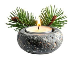 Lit candle in stone holder with pine branches and a dark backdrop