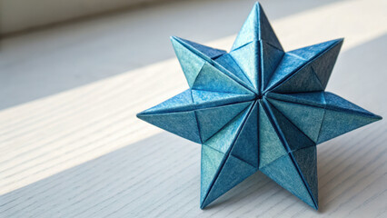 Geometric forms iconography visual. metallic blue origami modular star sits on light wooden surface, casting soft shadow