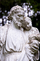Obraz premium Close Up of a White Stone Statue of a Man Holding a Child