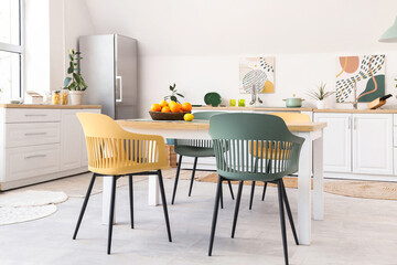 Interior of stylish kitchen with citruses on table