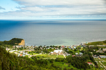 Aerial View of a Coastal Town With a Church in the Foreground and the Ocean in the Background, in Gaspesia, Quebec, Canada