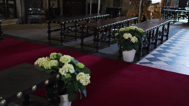 wedding aisle lined with pale hydrangeas and elegant dark benches