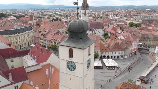 Drone footage orbiting The Council&rsquo;s Tower in Sibiu, with Small Square and Cathedral visible in the background, highlighting architectural details.