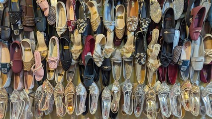 Row of colorful hand made traditional Rajasthan style shoes up for sale at street side in Area Hazro Attock. &lrm;November &lrm;28, &lrm;2025 