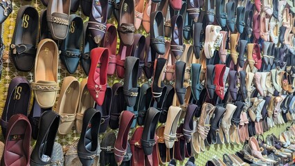 Row of colorful hand made traditional Rajasthan style shoes up for sale at street side in Area Hazro Attock. &lrm;November &lrm;28, &lrm;2025 