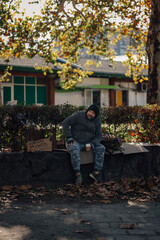 Homeless man needing food on autumn street