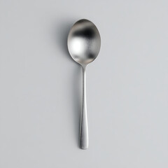 Top view of a single metal spoon in black and white