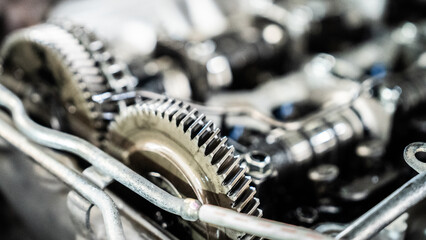 A close up of a gear with a blurry background. The gears are old and rusty, giving the image a...