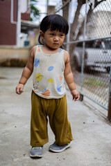 Toddler Is Playing Happily In Front Of House