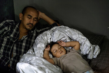 Dad Sleeping Beside Young Child In Daytime