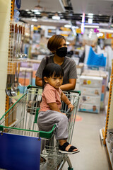 Mom And Child Shop With Cart in Market