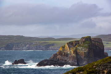 Dramatic Rocky Cliffs and Ocean Waves on a Cloudy Day in Ireland